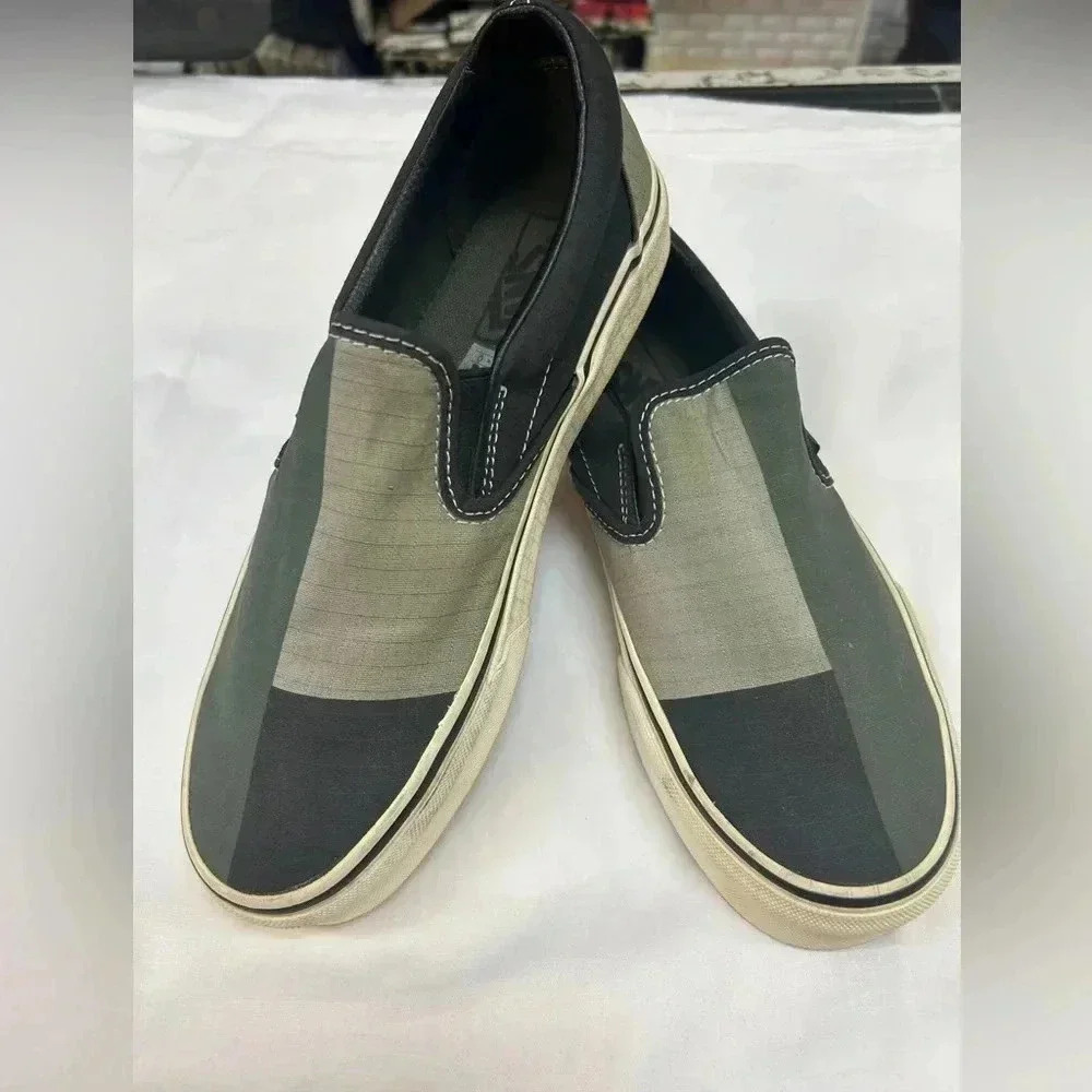 green and black VANS slip on